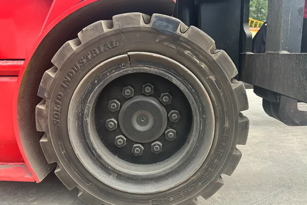 Close-up of forklift solid tire and front axle