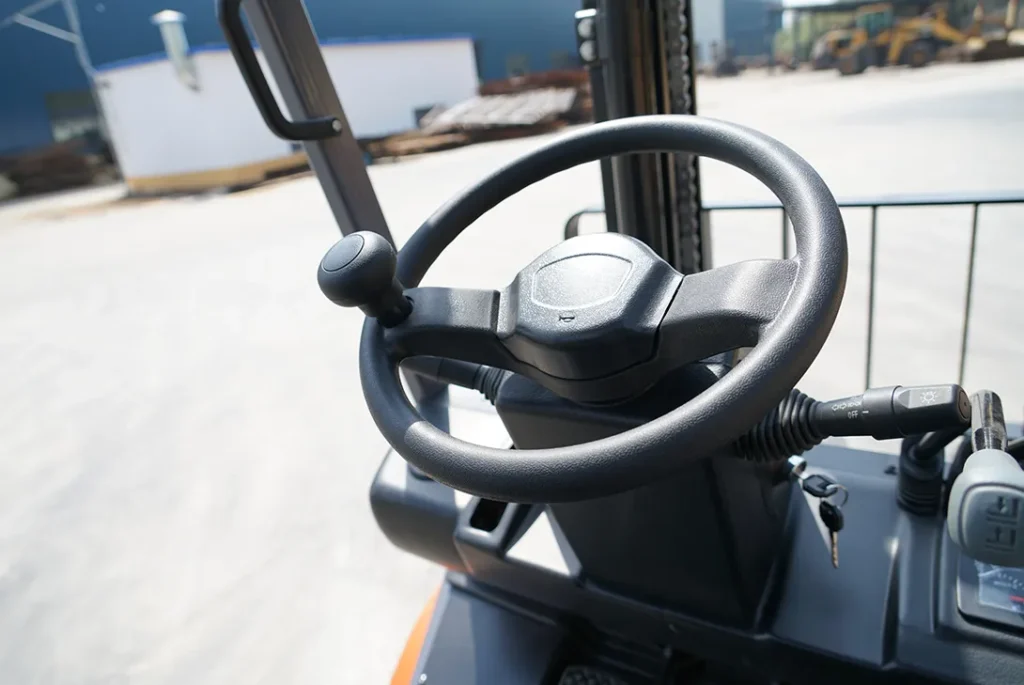 Steering wheel and dashboard of red electric forklift